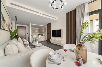 a living room with a couch and a table with wine glasses at FIRST CLASS 3BR Trendy Luxe Getaway in Dubai