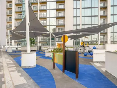 a playground in a building with blue carpet at FIRST CLASS 3BR Trendy Luxe Getaway in Dubai