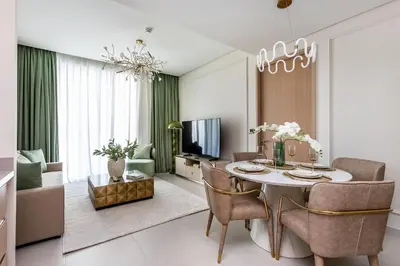 a living room with a table and chairs and a television at Dubai Mall access Vida Stunning Design in Dubai