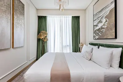 a bedroom with a large bed with a chandelier at Dubai Mall access Vida Stunning Design in Dubai