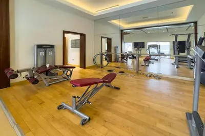 a gym with several exercise equipment in a room at Urban Skyline Haven Near Burj Khalifa in Dubai