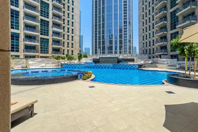 a large swimming pool in a city with tall buildings at Urban Skyline Haven Near Burj Khalifa in Dubai