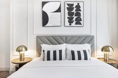 a bedroom with a bed with black and white pillows at StayMada - Torch Tower Marina Walk Gym and Sauna in Dubai