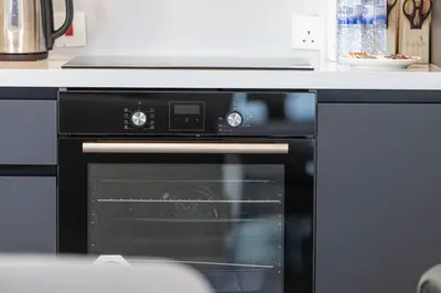 a black oven in a kitchen with a counter at StayMada - Torch Tower Elegant Marina Retreat in Dubai
