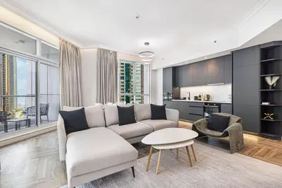 a living room with a couch and a table at StayMada - Torch Tower Elegant Marina Retreat in Dubai