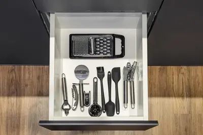 a drawer filled with kitchen utensils on a shelf at New 1BR with Rooftop Pool and Amazing View in Dubai