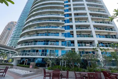 a tall building with chairs in front of it at Vacay Lettings - Lake Terrace JLT - Walk to Metro in Dubai
