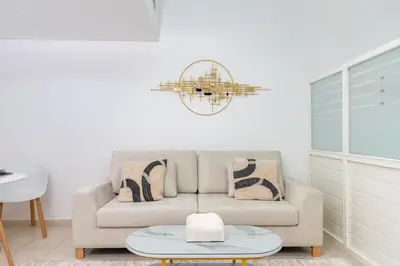a living room with a couch and a chandelier at Vacay Lettings - Lake Terrace JLT - Walk to Metro in Dubai