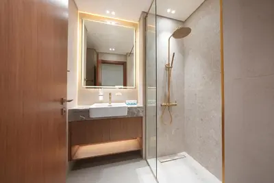a bathroom with a sink and a glass shower at Premium Stay at High-Floor Trillionaire Studio in Dubai