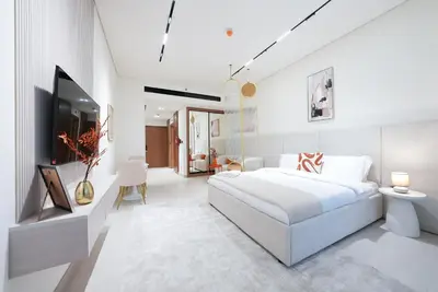 a white bedroom with a large white bed and white walls at Premium Stay at High-Floor Trillionaire Studio in Dubai