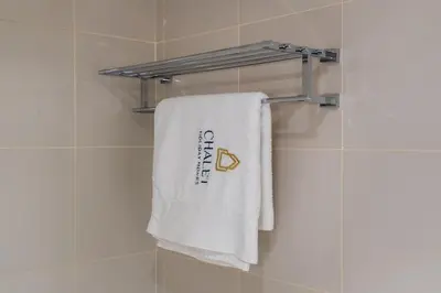 a towel hanging on a towel rack in a bathroom at DAMAC Cour Jardin - Pool & Gym - Free Parking in Dubai