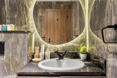 a bathroom with a sink and a large mirror at Bookable Studio Room Joya Blanca,Arjan with Tennis court access in Dubai