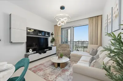 a living room with a couch and a tv at Close to Ras Al Khor Wildlife Sanctuary, Just Minutes from Dubai Mall and Burj Khalifa, and Surrounded by Exceptional Amenities - Harbour Views Tower 1, Dubai Creek Harbour by Deluxe Holiday Homes in Dubai