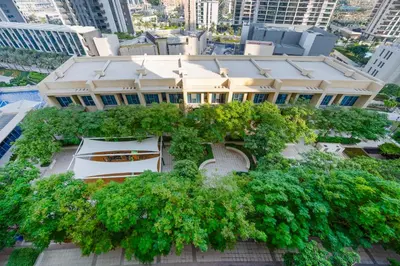 an overhead view of a building with trees around it at Close to Ras Al Khor Wildlife Sanctuary, Just Minutes from Dubai Mall and Burj Khalifa, and Surrounded by Exceptional Amenities - Harbour Views Tower 1, Dubai Creek Harbour by Deluxe Holiday Homes in Dubai