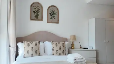 a bedroom with a bed with two pictures on the wall at Chic Downtown Studio Few Steps to Burj Khalifa by Simply Comfort in Dubai