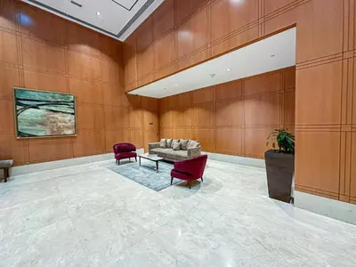 a living room with a couch and two chairs at Chic Downtown Studio Few Steps to Burj Khalifa by Simply Comfort in Dubai