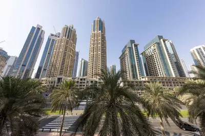 a city with palm trees in front of tall buildings at VayK - Great 1BR in Downtown near Burj Khalifa in Dubai
