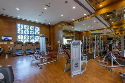 a gym with several treadmills and exercise bikes at VayK - Great 1BR in Downtown near Burj Khalifa in Dubai