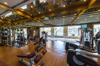 a gym with several treadmills and cardio machines at VayK - Great 1BR in Downtown near Burj Khalifa in Dubai