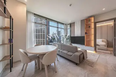 a living room with a table and a couch at Bright 1BR - Unit 1806 - City Views & Fast Wi-Fi in Dubai