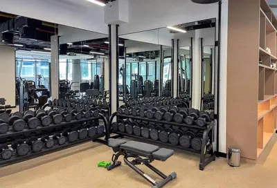 a gym with several rows of dumbbells in it at Bright 1BR - Unit 1806 - City Views & Fast Wi-Fi in Dubai