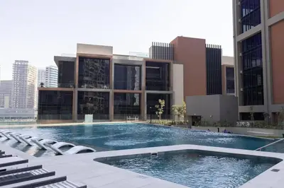 a large swimming pool in front of a building at Bright 1BR - Unit 1806 - City Views & Fast Wi-Fi in Dubai
