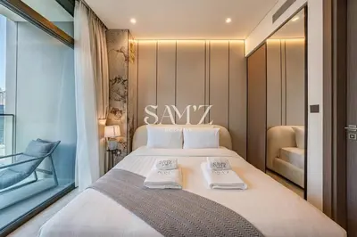 a bedroom with a large bed with towels on it at Bright 1BR - Unit 1806 - City Views & Fast Wi-Fi in Dubai