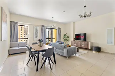 a living room with a table and a couch at VayK - Beautiful 1BR in JBR near the Beach in Dubai