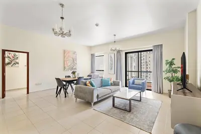 a living room with a couch and a table at VayK - Beautiful 1BR in JBR near the Beach in Dubai