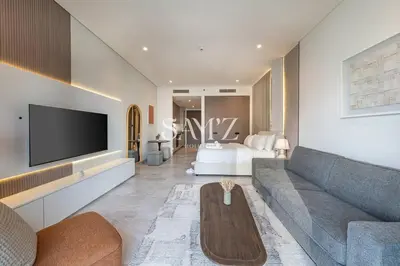 a living room with a couch and a tv at Studio Escape - Unit 1805 - Near Downtown! in Dubai