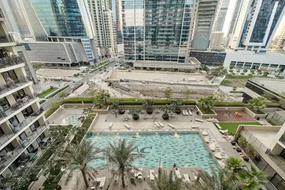 an overhead view of a large swimming pool in a city at FIRST CLASS 1BR Pool View & Prime Location in Dubai