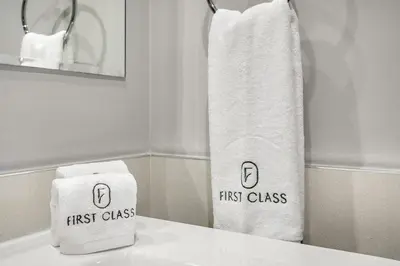 two towels sitting on top of a bathroom sink at FIRST CLASS 1BR Pool View & Prime Location in Dubai