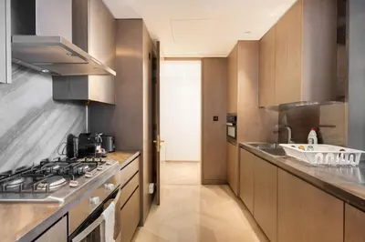 a large kitchen with a stove and a sink at Five Palm Luxury Stay 2BR with Pool & Beach Access in Dubai