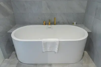 a white bath tub in a bathroom with a towel at Five Palm Luxury Stay 2BR with Pool & Beach Access in Dubai