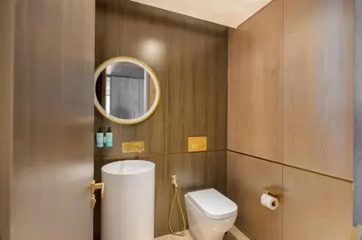 a bathroom with a toilet and a mirror at Five Palm Luxury Stay 2BR with Pool & Beach Access in Dubai