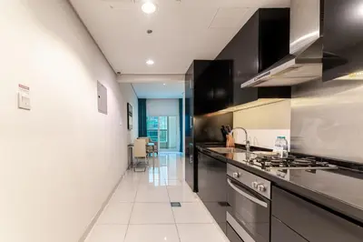 a kitchen with a sink and a stove at HAVN - Studio in Cour Jardin, Business Bay in Dubai