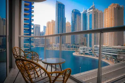 a balcony with a table and chairs and a view of the city at Khayali Marina Holiday Homes Dubai Marina JBR in Dubai