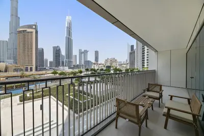 a balcony with two chairs and a view of the city at Chic 3BR in Downtown with Burj Khalifa View in Dubai
