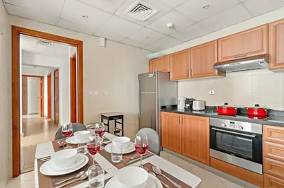 a kitchen with a table with plates and wine glasses at FIRST CLASS 2BR Breathtaking Marina Views in Dubai