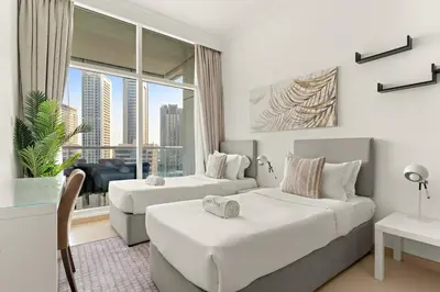 a hotel room with two beds and a window at FIRST CLASS 2BR Breathtaking Marina Views in Dubai