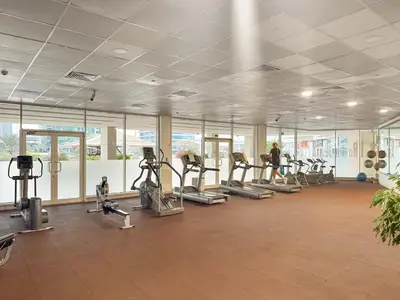 a gym with treadmills and ellipticals in a building at FIRST CLASS 2BR Breathtaking Marina Views in Dubai