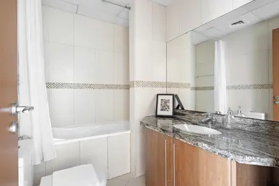 a bathroom with a sink and a tub at VayK - Spacious 2BR in JLT with Marina Views in Dubai