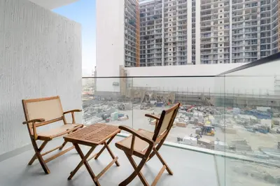 two chairs and a table on a balcony with a view at VayK - Modern Studio with Great Amenities in Dubai