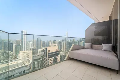 a balcony with a couch and a view of a city at VayK - Ultra-Luxury 3BR Marina Retreat with Stunning View in Dubai