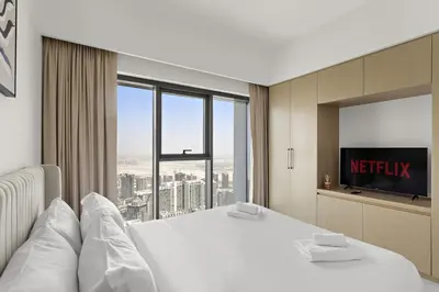 a hotel room with a bed and a large window at VayK - Stylish 1BR in Prime Downtown Location in Dubai