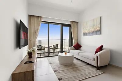 a living room with a couch and a table at VayK - Stylish 1BR in Prime Downtown Location in Dubai