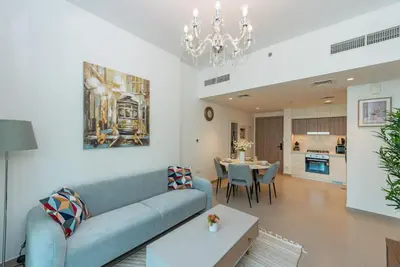 a living room with a couch and a table at VayK - Brand New 1BR in Dubai Hills in Dubai