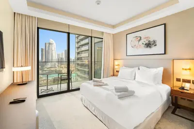 a bedroom with a large white bed and a large window at VayK - Exceptional 3BR at Address Dubai Opera in Dubai