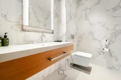 a white bathroom with a sink and a toilet at VayK - Exceptional 3BR at Address Dubai Opera in Dubai