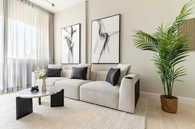a living room with a couch and a table at VayK - Luxurious 2BR in JVC in Dubai